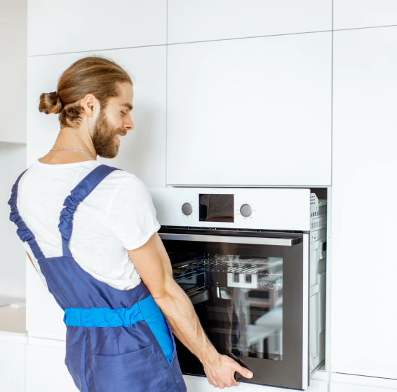 worker installing kitchen oven